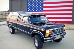 Exterior view of Big Blackie, a black 1981 Ford F-150 showing original trim and restoration details.