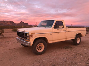 White 1981 Ford F150 4x4 with a water tank in the bed, an entrant in the 2020 Virtual Truck Show.