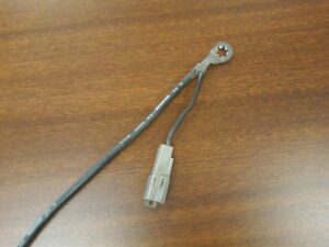 A comparison chart of Ford ground wire part numbers and a photo of the 14303-A cable with its auxiliary ECA computer connector.