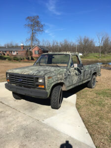 A camouflage-patterned 1984 Ford F-150 Styleside long bed 4x4, known as the Georgian Hulk, featured in the 2020 Virtual Truck Show.