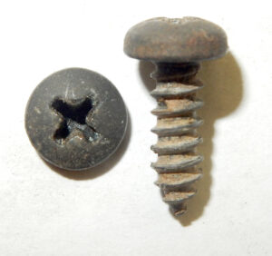 A comparison of two different screws used for Ford armrest supports: a long hex-head N610939 screw and a shorter Phillips-head screw.