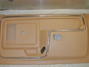 An exploded view from the Ford Master Parts Catalog showing a door panel assembly with armrests and decorative trim inserts.