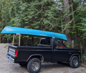 Satin black 1980 Ford F150 Ranger XLT short bed 4x4 with aftermarket wheels and a roll-up tonneau cover, an entrant in the 2020 Virtual Truck Show.