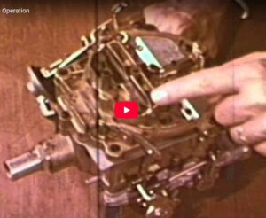 Close-up of a carburetor linkage showing the choke plate closed and the fast idle cam engaged for a cold start.