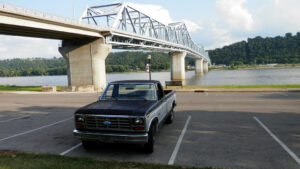 A 1984 Ford F150 XL featuring a rebuilt 300 inline-six engine and Type 9 mirrors, shown as Entrant #12 in the 2020 Virtual Truck Show.