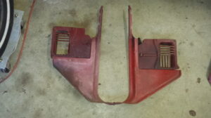 Comparison photos of red and tan Ford truck kick panels, showing the back-side casting numbers and the physical differences between vented and non-vented versions.