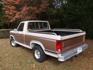 A two-tone tan and brown 1982 Ford F100 XL short bed with alloy wheels, restored to factory paint codes for the 2020 Virtual Truck Show.