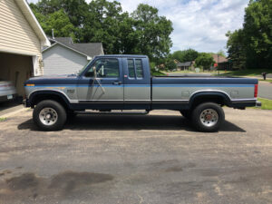 A dark blue Ford F250 XLT Lariat with a 460 V8 and Dana 60 front axle, entered as #18 in the 2020 Virtual Truck Show.