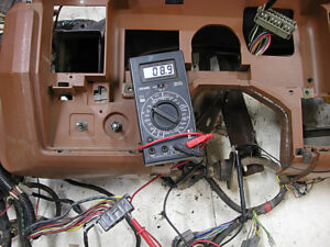 A technical page featuring a Ford parts catalog table for instrument cluster circuits and gauges, with navigation tabs for troubleshooting and repair.