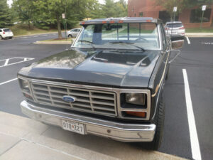 A brown 1985 Ford F150 Lariat regular cab long bed, powered by a high-performance 390 FE big block engine, featured in the 2020 Virtual Truck Show.