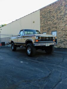 Tan and brown 1986 Ford F250 XLT Lariat parked on a street, an entrant in the 2020 Virtual Truck Show.