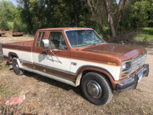 Tan and cream two-tone Ford F250 Lariat regular cab parked in a grassy field, an entrant in the 2020 Virtual Truck Show.
