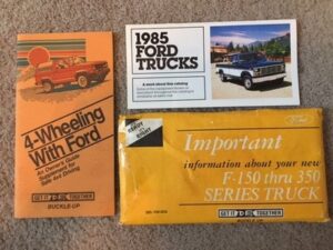 Original 1985 Ford F-Series owner's manuals, window sticker, and warranty booklets.