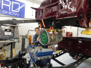 A 1981 Ford F150 Ranger 4WD in the process of a frame-off restification, showing the high-performance 400 V8 engine and powder-coated chassis components.