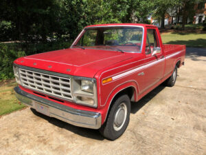 Candy Apple Red 1980 Ford F150 Custom regular cab with original steel wheels, nicknamed the Truck of Doom, an entrant in the 2020 Virtual Truck Show.