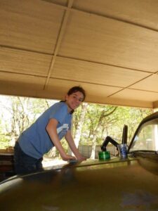 Alt Text: A photo of a weathered, bright green 19750 Chevrolet Squarebody pickup truck, nicknamed "Ugly Green," parked in a workshop or driveway setting.